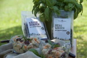 Couscous-Salat in zwei Gläsern mit Basilikum, dahinter Schalk Mühle Käferbohnen und Berglinsen