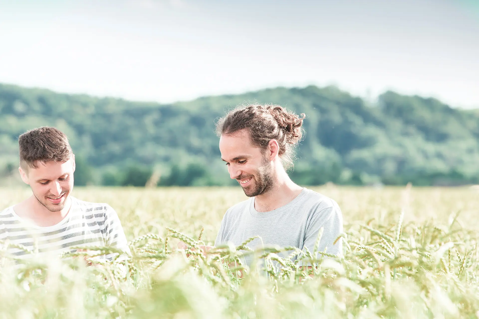 Franz and Rainer Schalk smiling in a sunny grain field