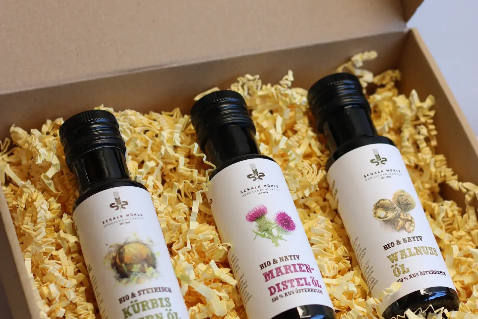 Gift box with three oil bottles: pumpkin seed, milk thistle, and walnut oil
