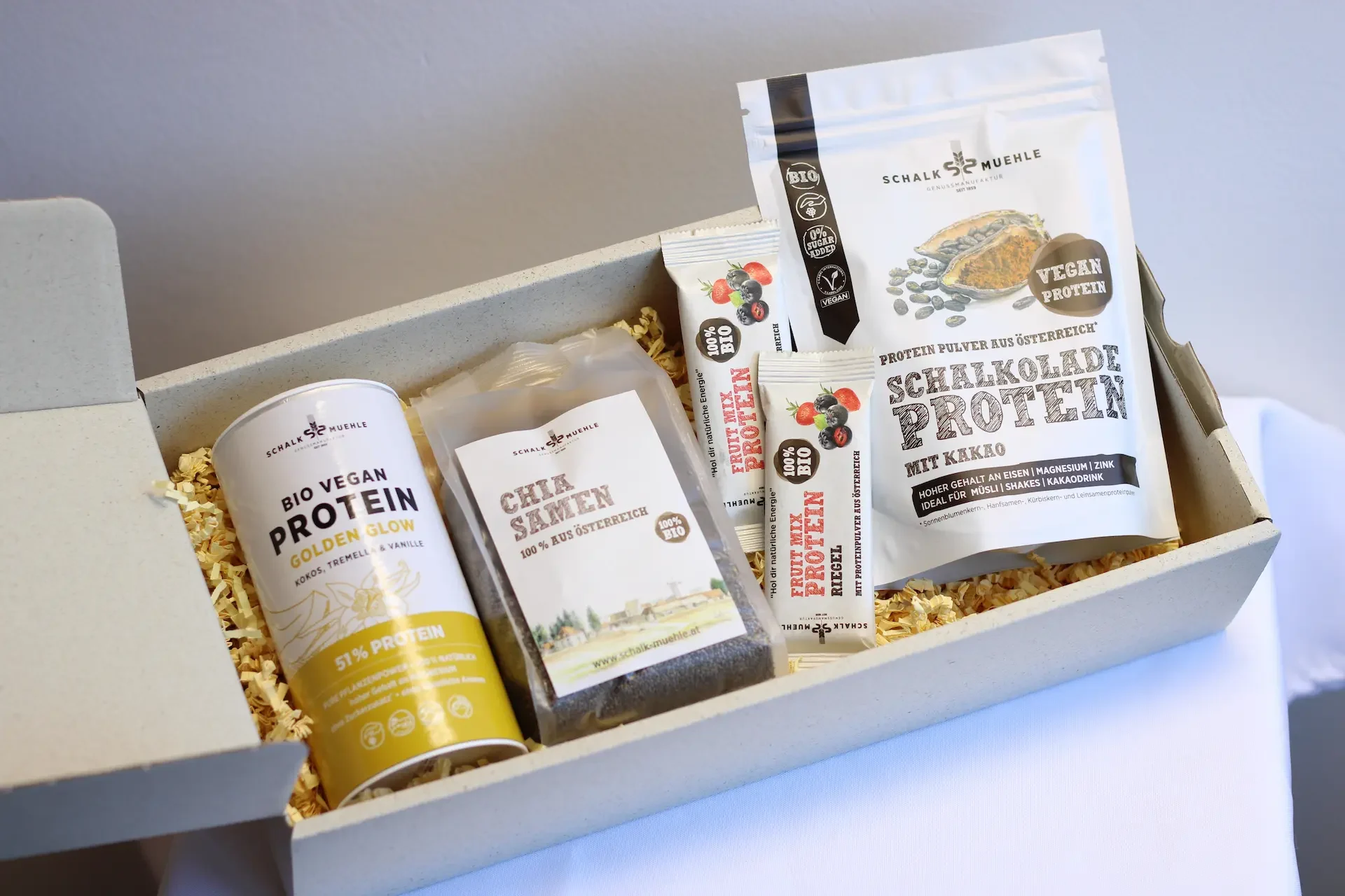 Gift box with Golden Glow Protein, chia seeds, protein bars, and cocoa protein
